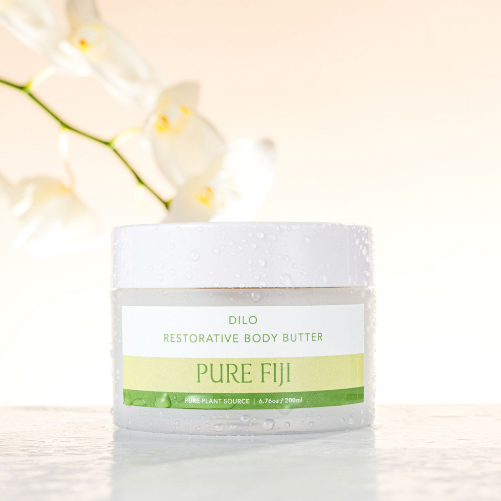 Jar of Pure Fiji body butter with white flowers in the background